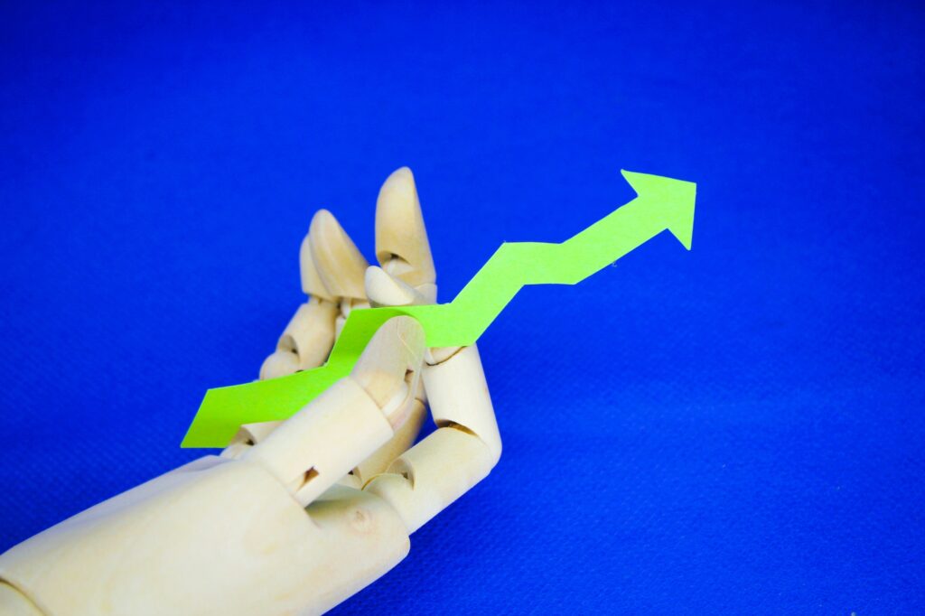hand holding up green arrow. rough concept of increase or increase in price
